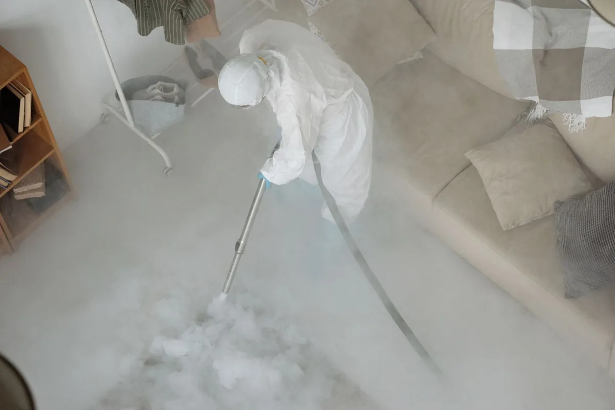 Biohazard cleanup technician in protective equipment, Slater, MO